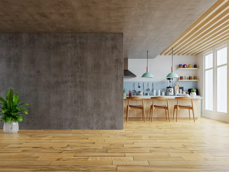 Bright open kitchen with a concrete feature wall, wood ceiling slats, and a breakfast bar