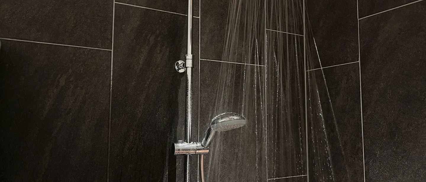 Rain shower in a tiled bathroom